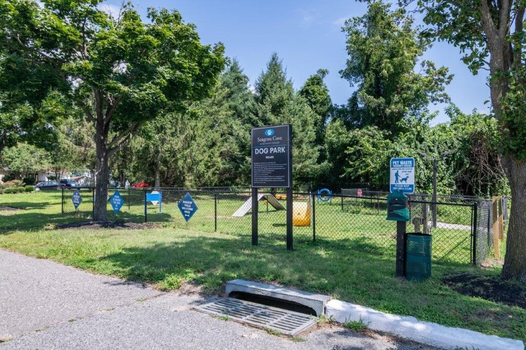a park with a fence and a sign