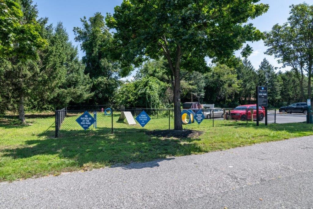a parking lot with blue and white signs on a fence