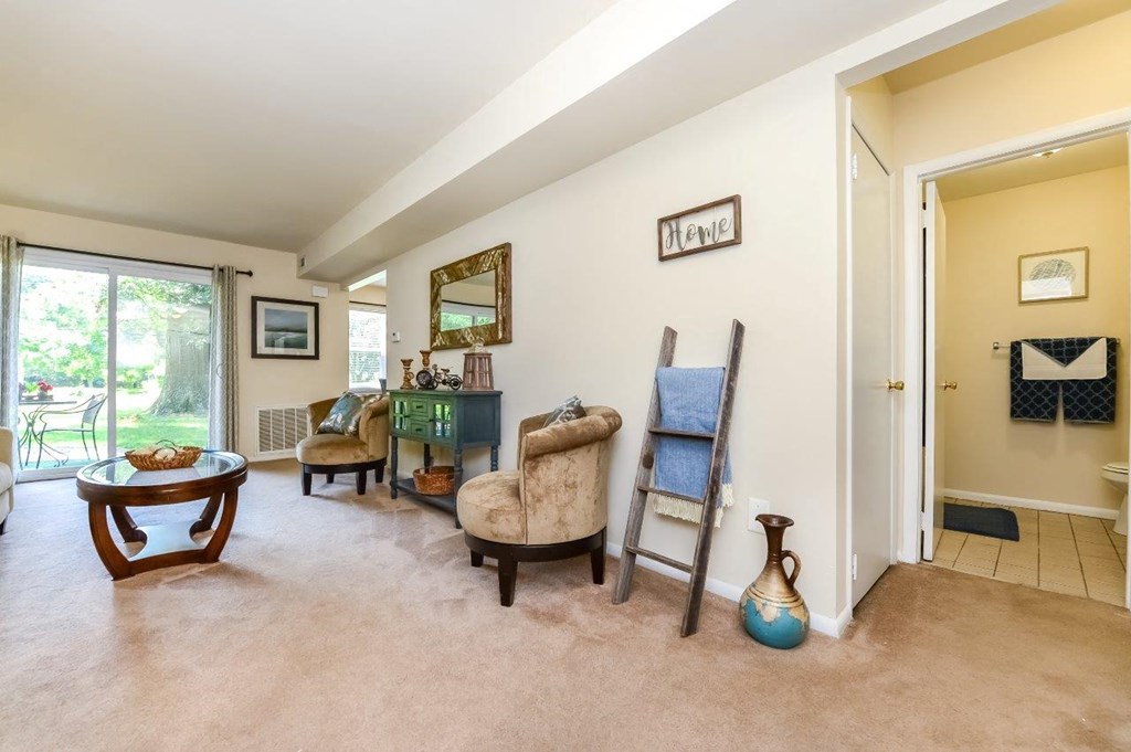 a living room with furniture and a door to a patio