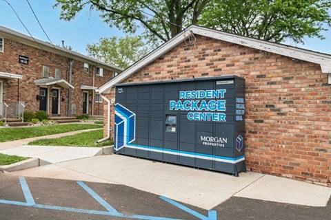 a small brick building with a sign for a rental package center