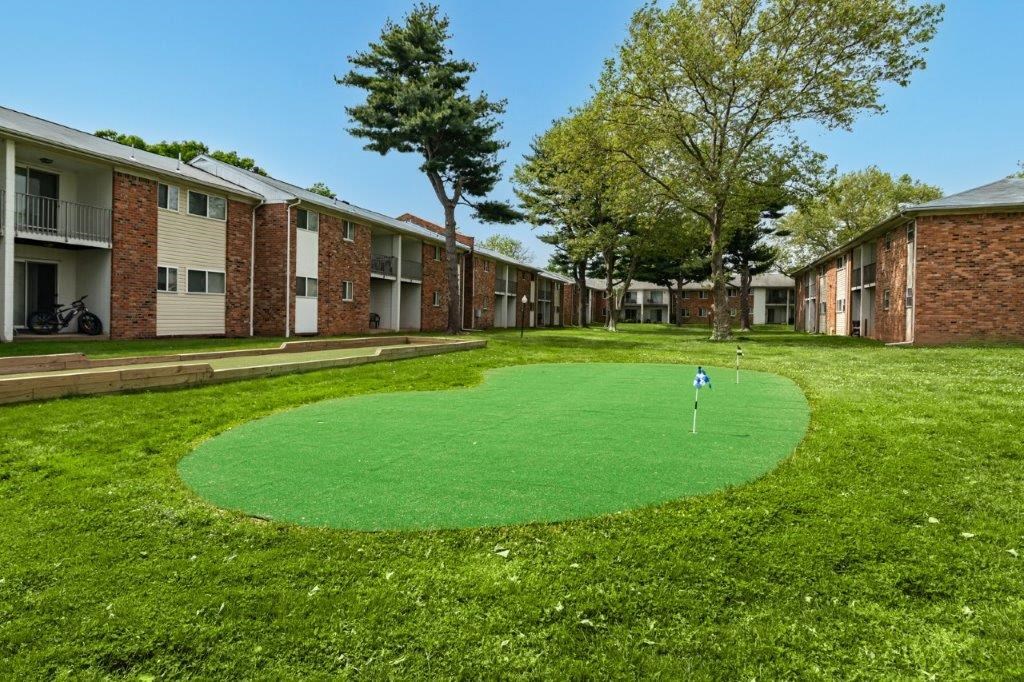a putting green in the middle of an apartment complex