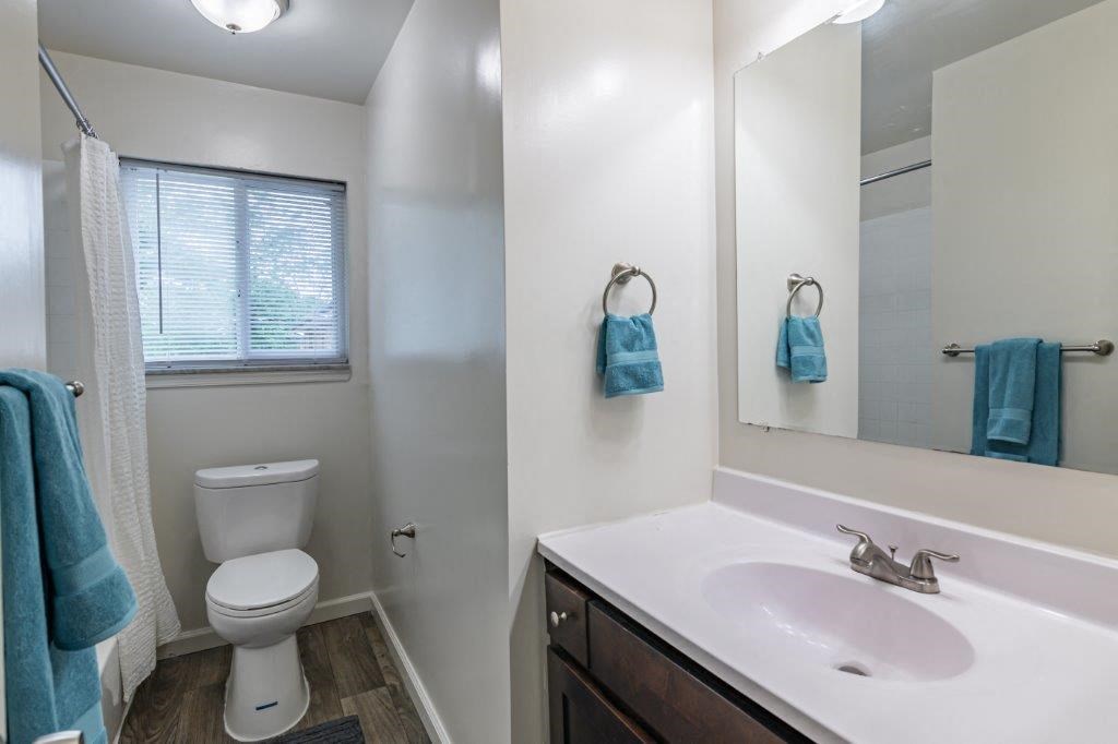 a bathroom with a sink toilet and a mirror