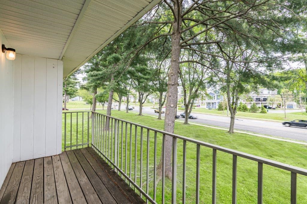the view from the porch of a house with trees