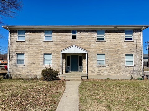 A two-story brick house with a front porch.