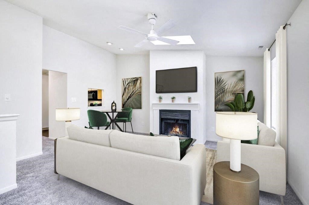 a living room with a white couch and a fireplace