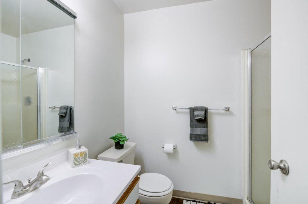 a bathroom with a sink toilet and a mirror