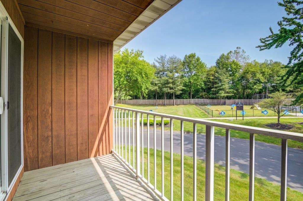 a balcony with a view of a park