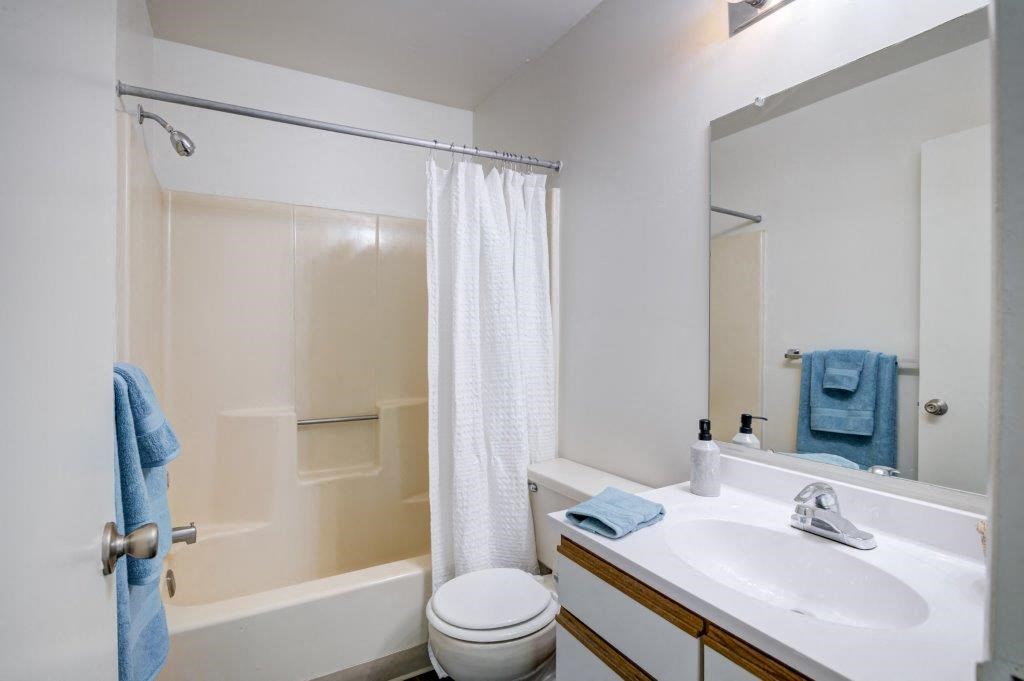 a bathroom with a sink toilet and a mirror