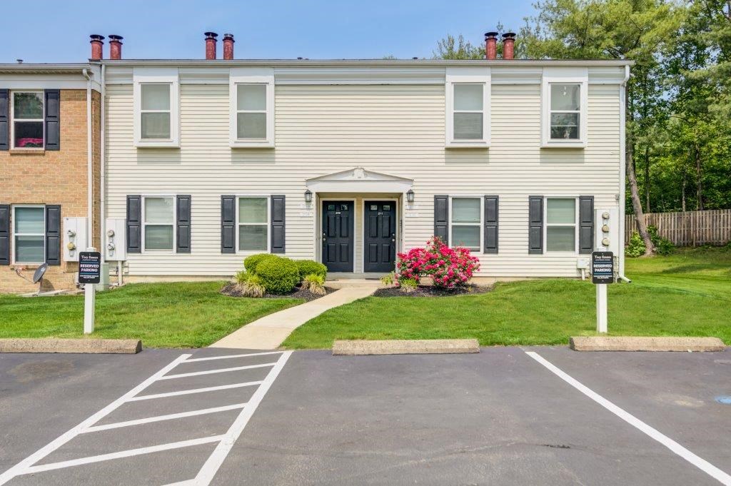 a large white house with a sidewalk in front of it