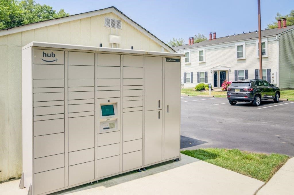 a small garage with a car parked in a driveway