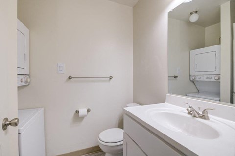 a bathroom with a sink toilet and a mirror