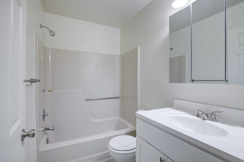 a bathroom with a sink toilet and a bath tub