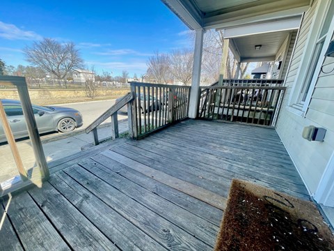 A wooden deck with a mat on it.