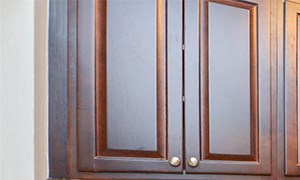 a kitchen with wood cabinets and stainless steel appliances