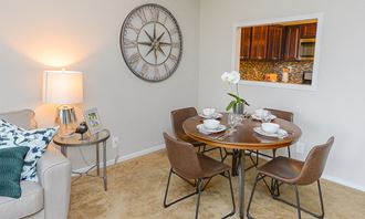 a dining room with a table and a large clock on the wall