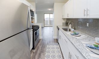 a kitchen with stainless steel appliances and white cabinets