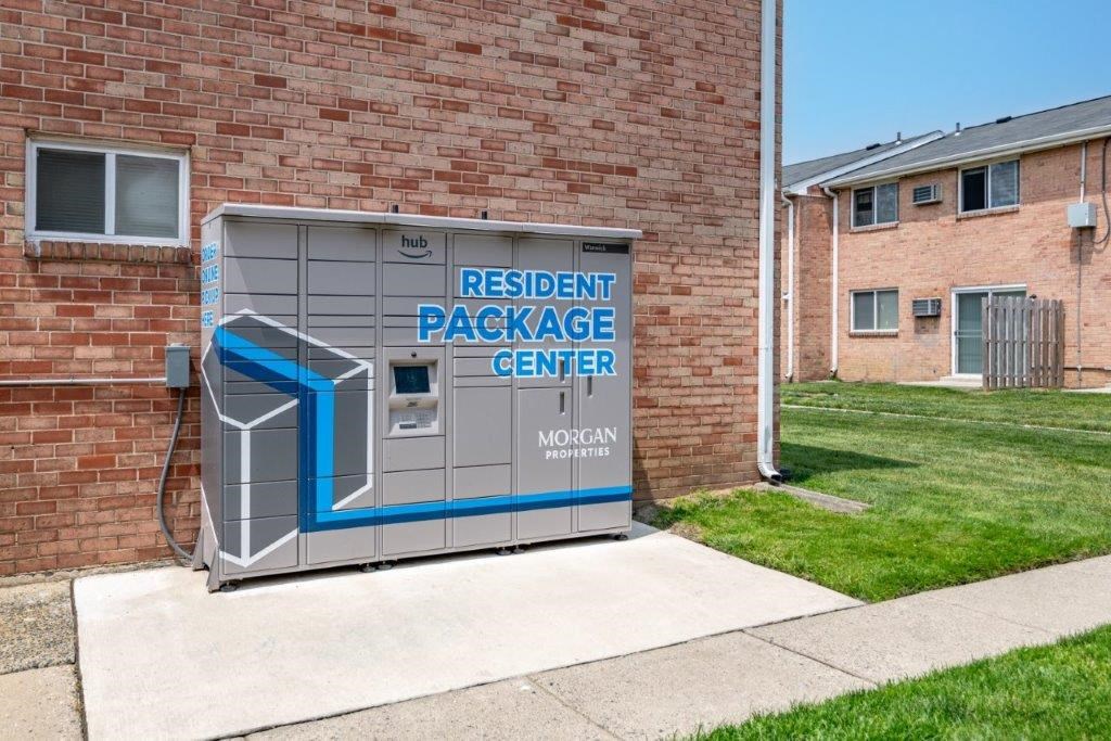 a small parking meter in front of a brick building