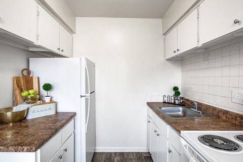 a small kitchen with white appliances and white cabinets