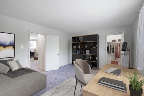 a living room with a couch and a desk