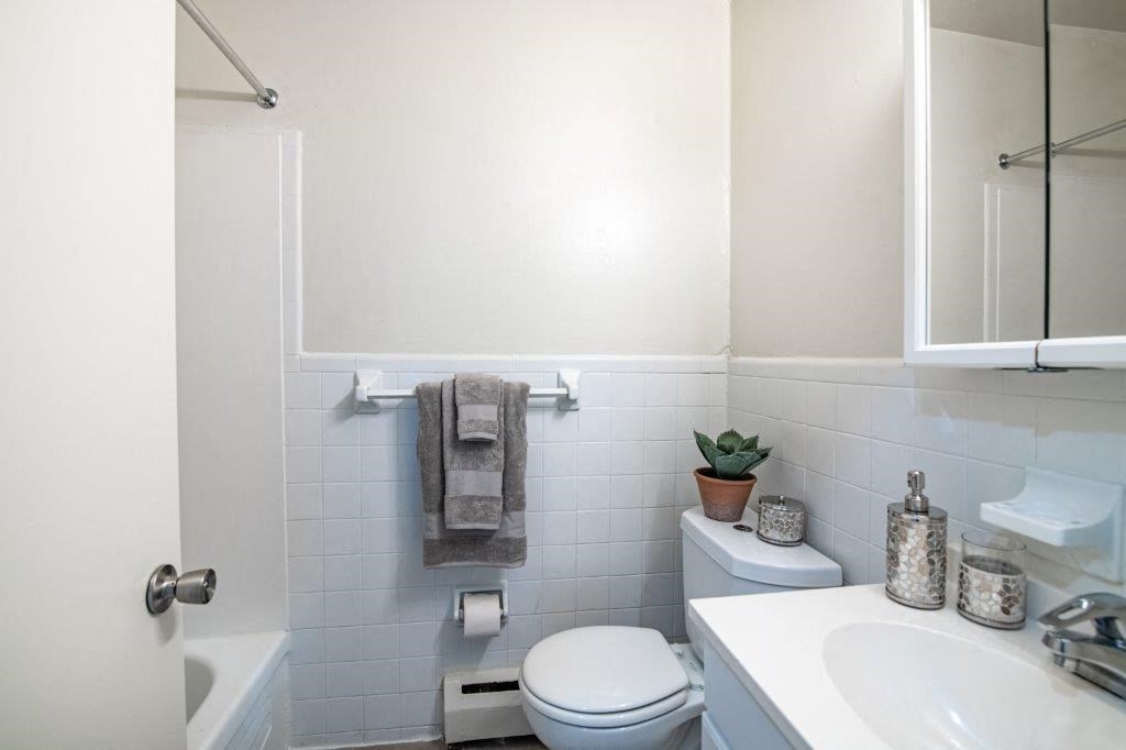 a white bathroom with a toilet and a sink