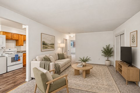 A living room with a couch, chair, and a coffee table.