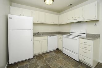a kitchen with white appliances and white cabinets