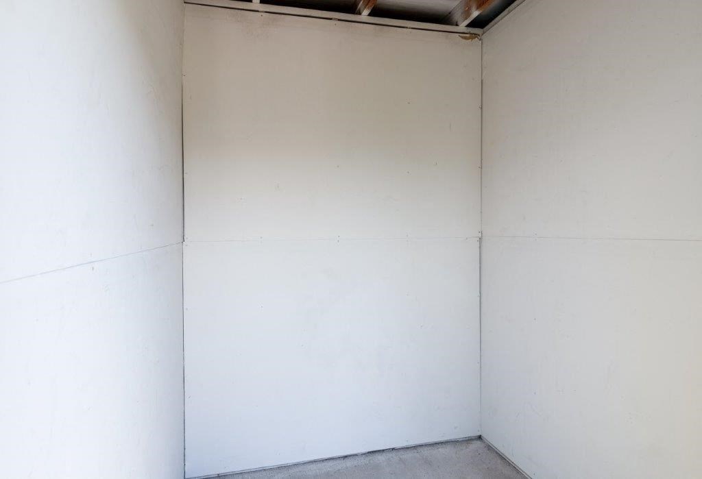a corner of a room with a white wall
