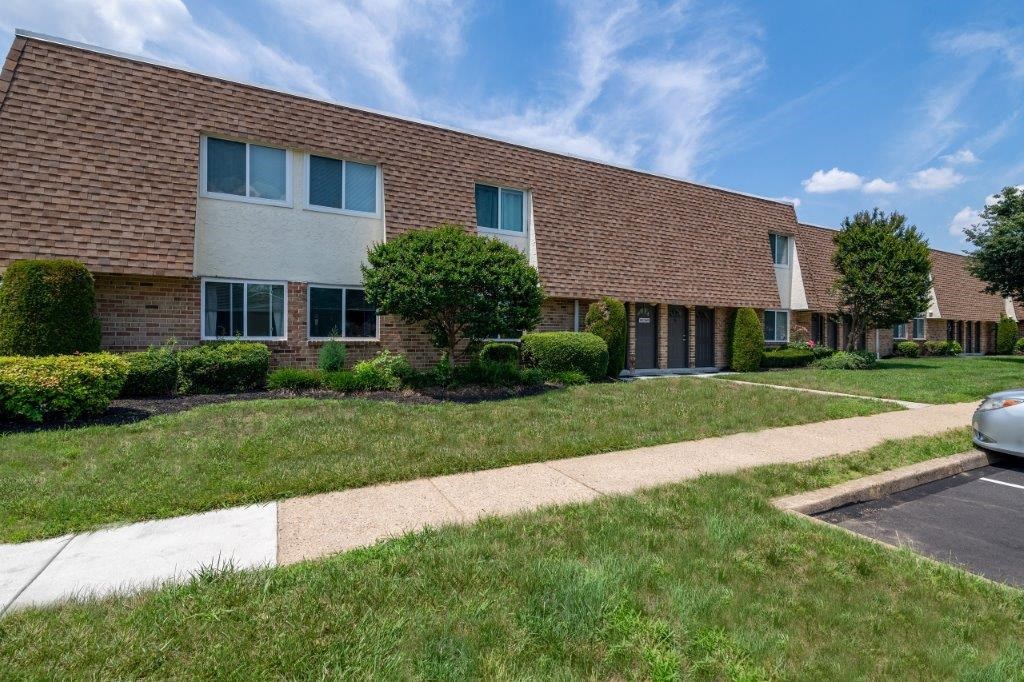 a brick building with a sidewalk in front of it