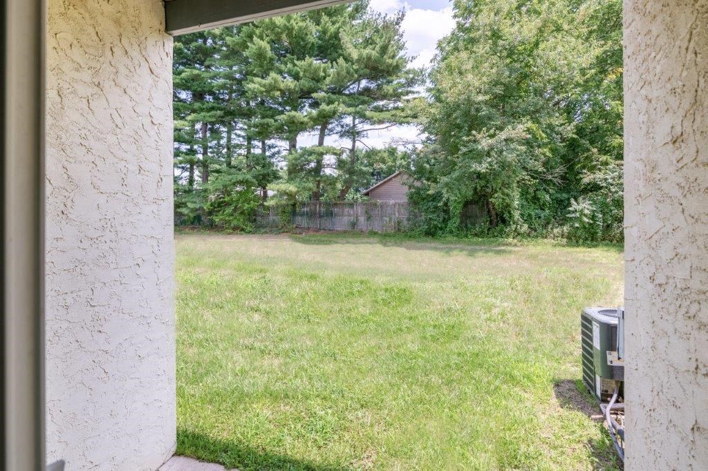 a view of a yard from a window of a house