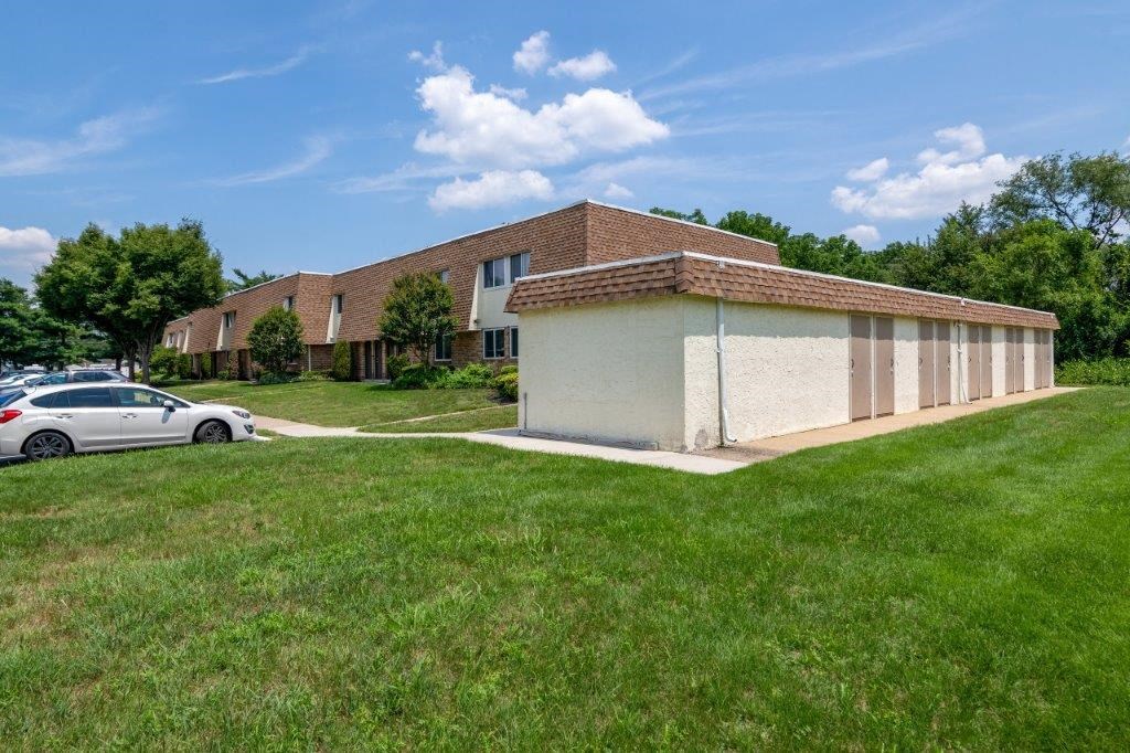 a white building with a car parked in front of it