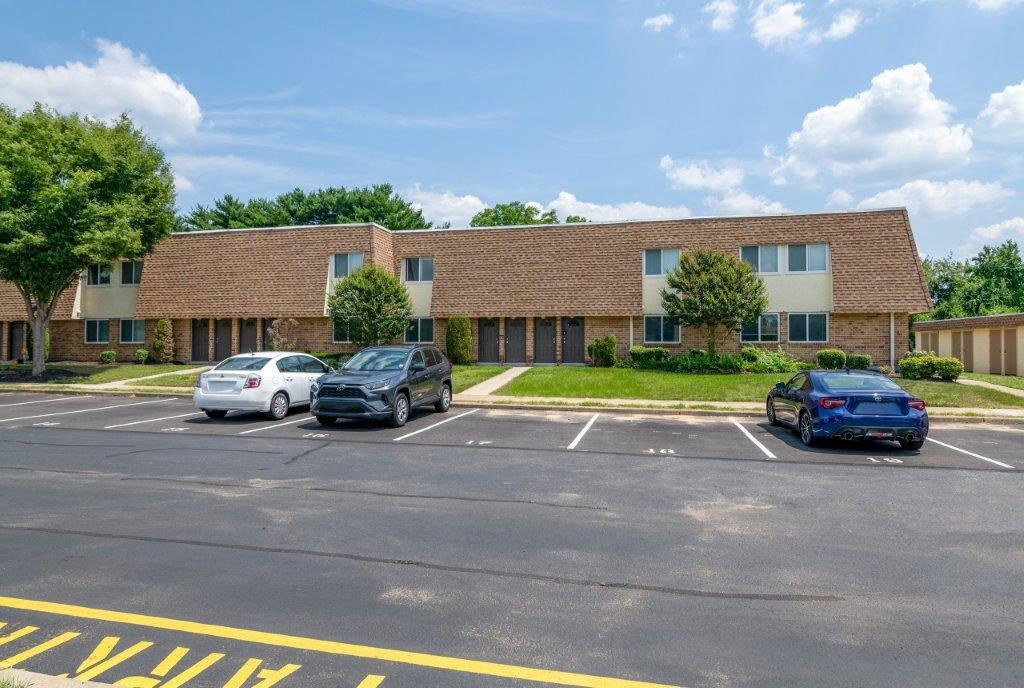 a parking lot with cars in front of a building