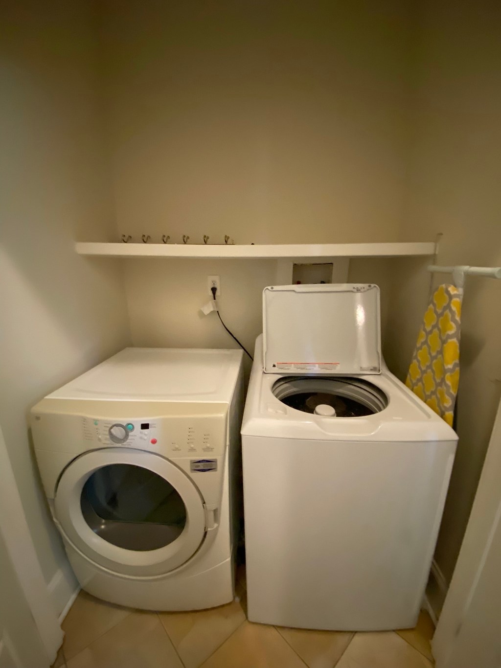 A white washing machine and dryer in a small laundry room.