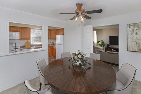 a dining room with a table and a ceiling fan