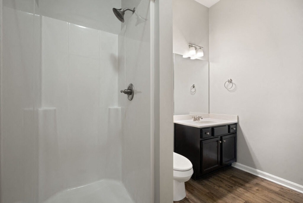 a bathroom with a shower and a sink and a toilet