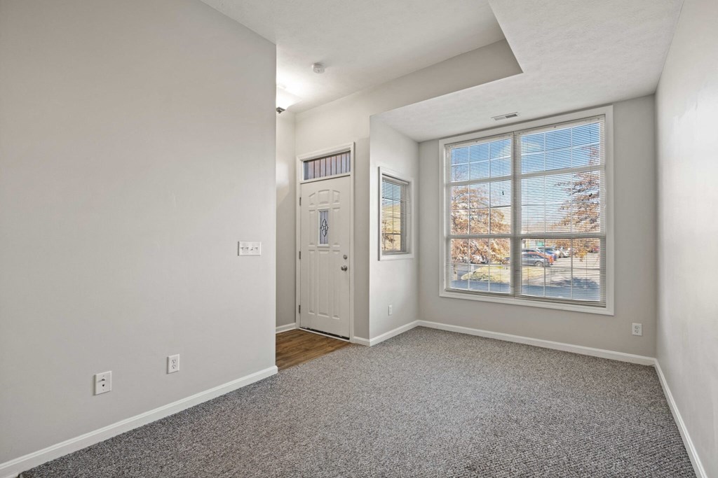 a living room with a large window and a door