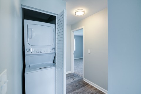 an empty laundry room with a washer and dryer