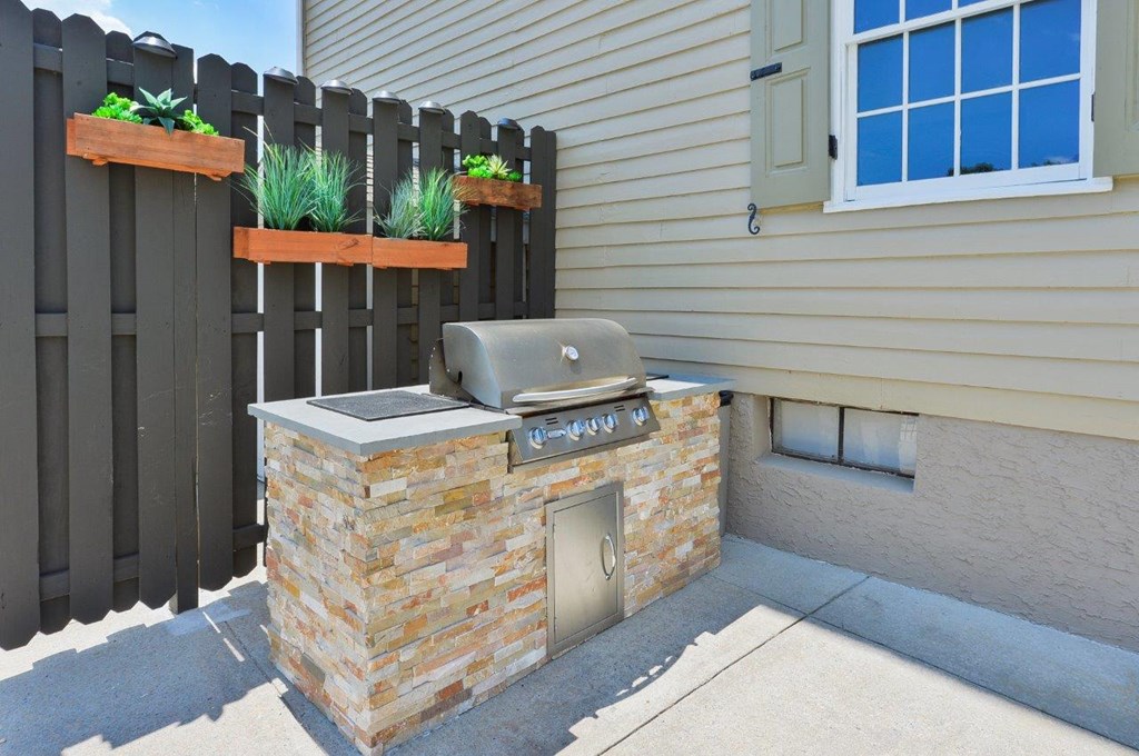 a backyard barbecue with a fence and a window