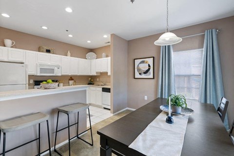 a kitchen and dining room with a table and chairs
