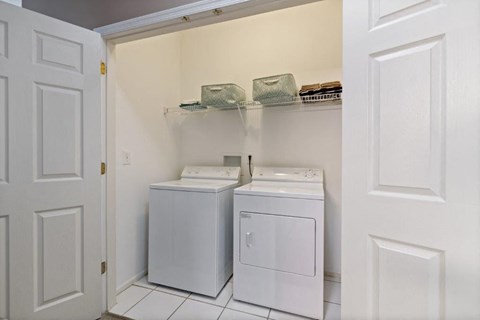 a laundry room with two washes and a dryer