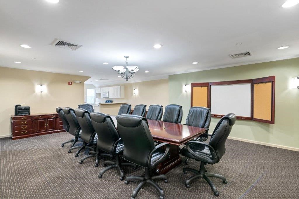 a conference room with a wooden table and chairs
