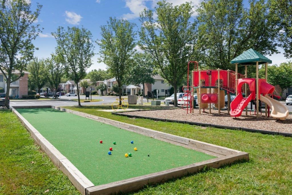 play a game of bocce ball at the playground at the community center