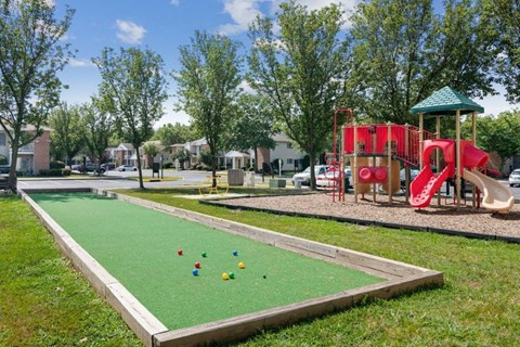 play a game of bocce ball at the playground at the community center