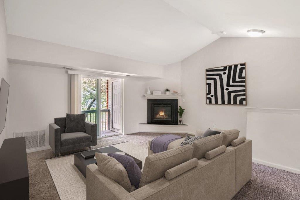 Staged living room with carpet and a fireplace