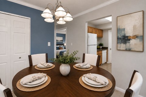 A dining room with a wooden table set for four.