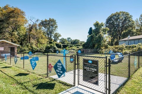 the dog park is fenced in with blue flags on the fence
