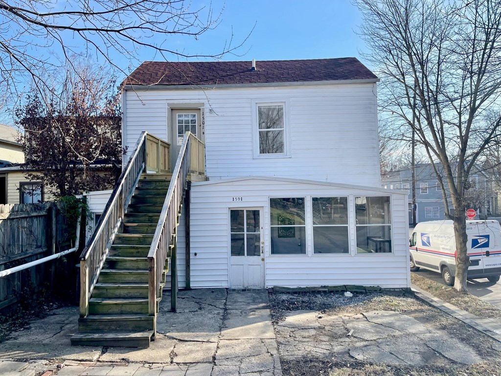 A white house with a mailbox on the right side.
