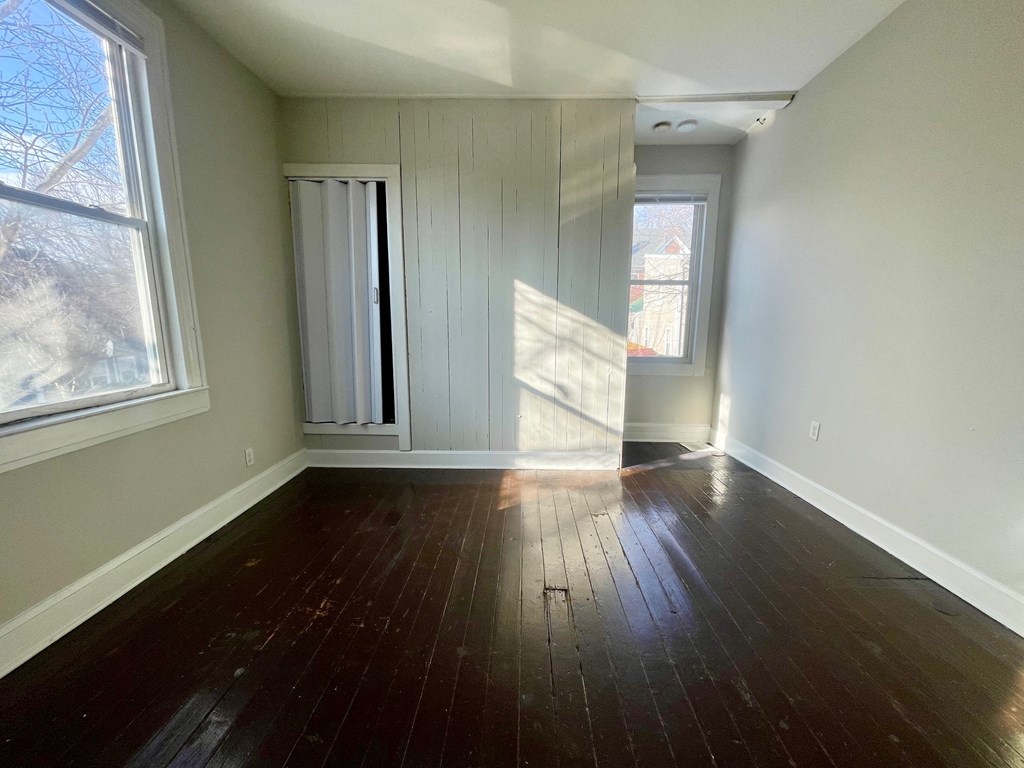 A room with wooden floors and a window.