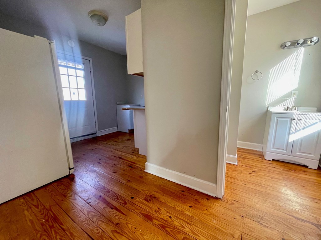 A room with wooden floors and white walls.