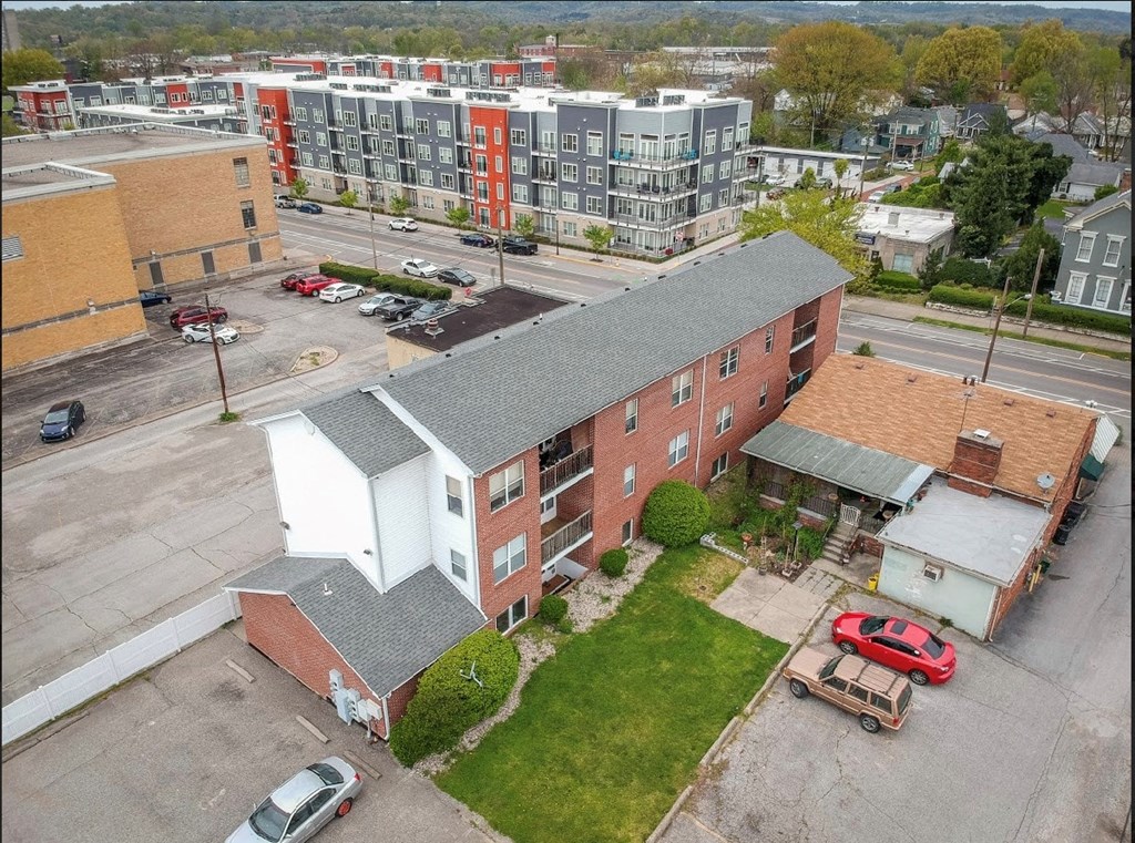 an aerial view of an apartment building and a parking lot