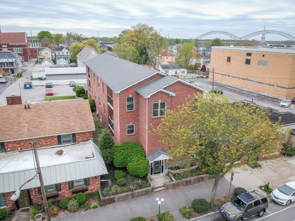 an aerial view of a brick building and a parking lot
